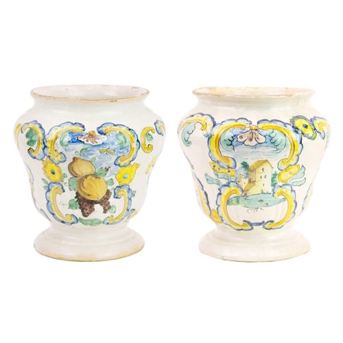 1120 - A pair of Italian Maiolica albarelli or drug jars. One dated 1742, of moulded waisted form, polychro... 