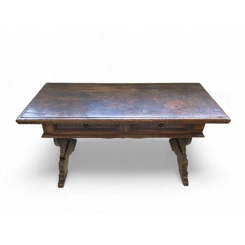 1121 - An Italian walnut writing table. Florentine, 17th century, fitted with two drawers and raised on vas... 