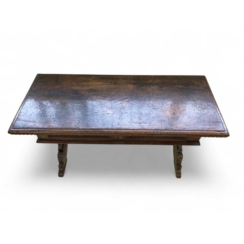 1121 - An Italian walnut writing table. Florentine, 17th century, fitted with two drawers and raised on vas... 