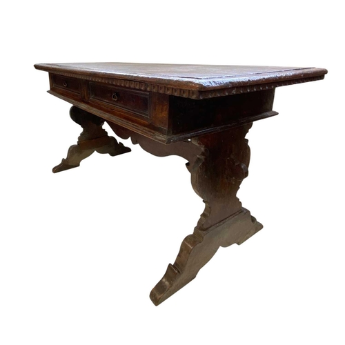 1121 - An Italian walnut writing table. Florentine, 17th century, fitted with two drawers and raised on vas... 