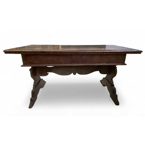 1121 - An Italian walnut writing table. Florentine, 17th century, fitted with two drawers and raised on vas... 