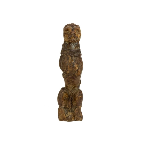 1130 - An oak 'Kings Beast' carved figure. Tudor, circa 1530, wearing a studded collar and with the tail cu... 