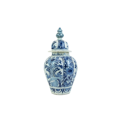 1133 - A Dutch Delft blue and white baluster vase and cover. Late 18th century, with a fluted body and Chin... 