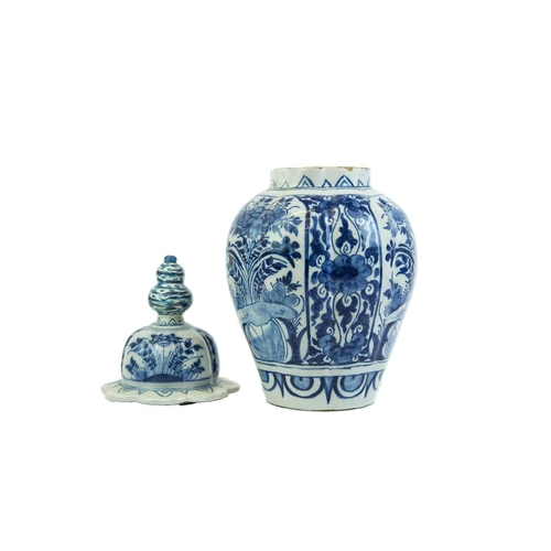 1133 - A Dutch Delft blue and white baluster vase and cover. Late 18th century, with a fluted body and Chin... 