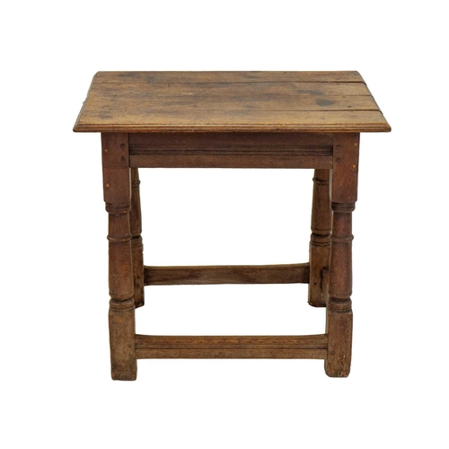 1149 - An English oak centre or altar table. 17th century, the four plank top raised on stout turned legs, ... 