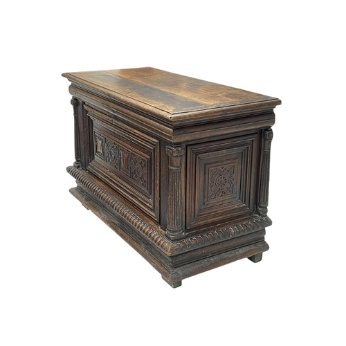 1157 - A French oak coffer. 17th century, with fluted column side supports flanking carved panels, on a gad... 