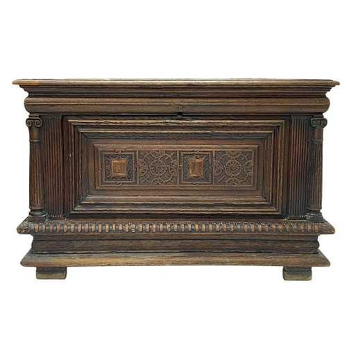 1157 - A French oak coffer. 17th century, with fluted column side supports flanking carved panels, on a gad... 