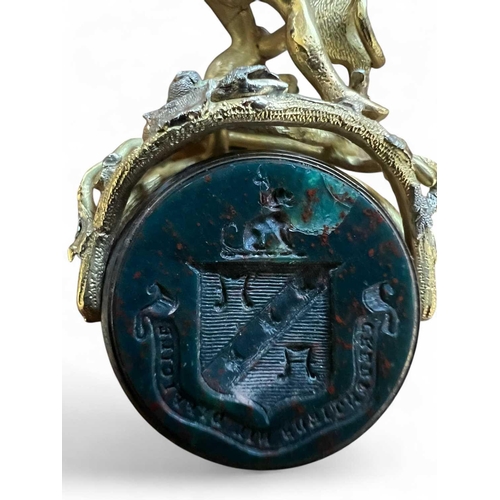 1160 - An impressive swivel seal locket In unmarked gold cast and chased as Hercules and the Lion. The open... 