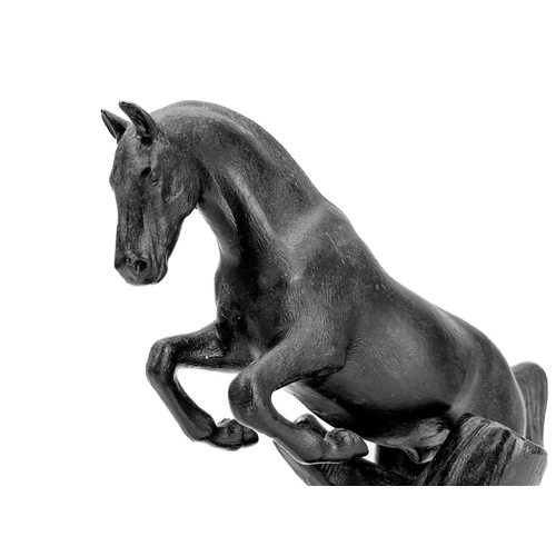 117 - A 20th century Russian cast iron model of a leaping horse. Impressed marks to base, height 19cm.