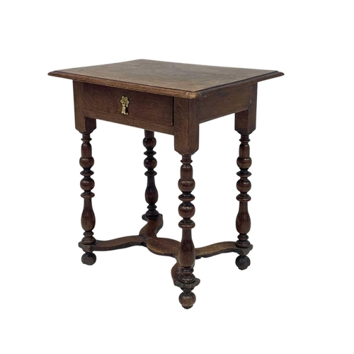 1176 - A William & Mary period oak side table. Fitted a single drawer and raised on cup and cover, and balu... 