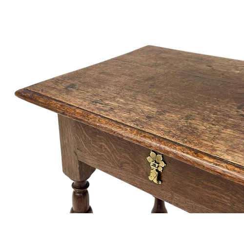 1176 - A William & Mary period oak side table. Fitted a single drawer and raised on cup and cover, and balu... 