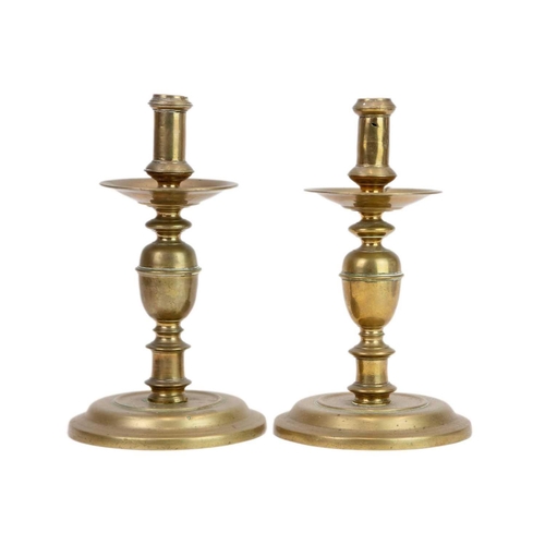 1178 - A matched pair of late 17th century continental brass candlesticks. Probably North European, with wi... 