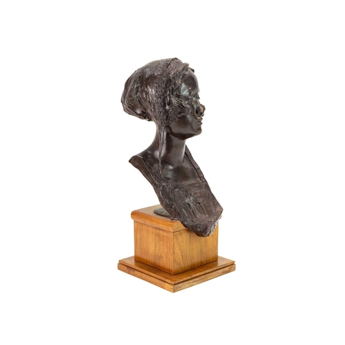 1186 - Edoardo Rubino (1874-1951). A bronze bust of a young woman, Early 20th century, cast wearing a bonne... 