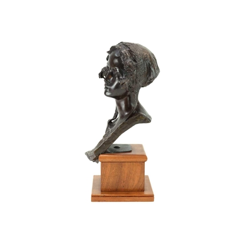 1186 - Edoardo Rubino (1874-1951). A bronze bust of a young woman, Early 20th century, cast wearing a bonne... 