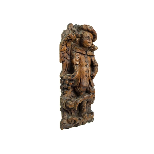 1187 - A Flemish carved oak plaque of a boy with grapes. 17th century, with one foot raised, height 27cm. M... 