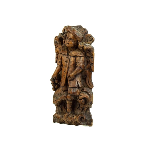 1187 - A Flemish carved oak plaque of a boy with grapes. 17th century, with one foot raised, height 27cm. M... 