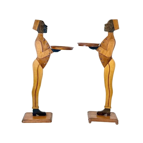 12 - A pair of mahogany figural dumb waiters. With lead weighted bases, height 98cm.