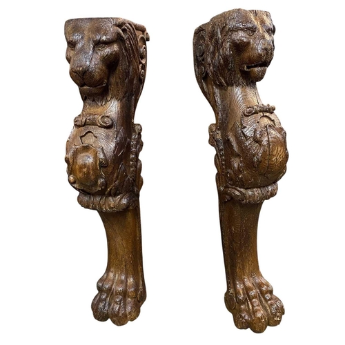 127 - A pair of carved corbels or supports. Probably 17th century, with lion mask crests, supporting a shi... 