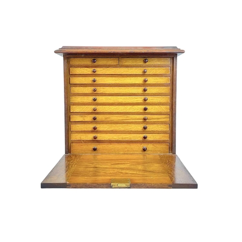 131 - A mahogany collectors coin cabinet. With fall front and an arrangement of eleven drawers, height 35c... 