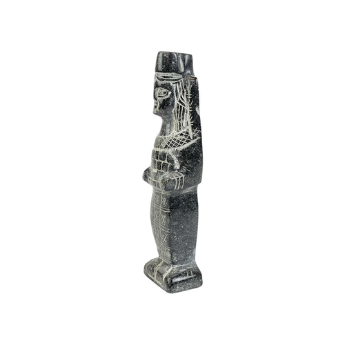 142 - An Egyptian carved black stone standing figure. 20th century, height 15cm.