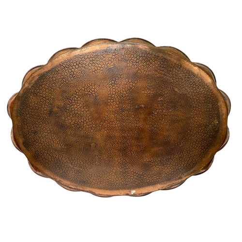 145 - A J & F Pool, Hayle oval copper tray. With a scalloped edge, engraved with two stylised fish, 42X58c... 