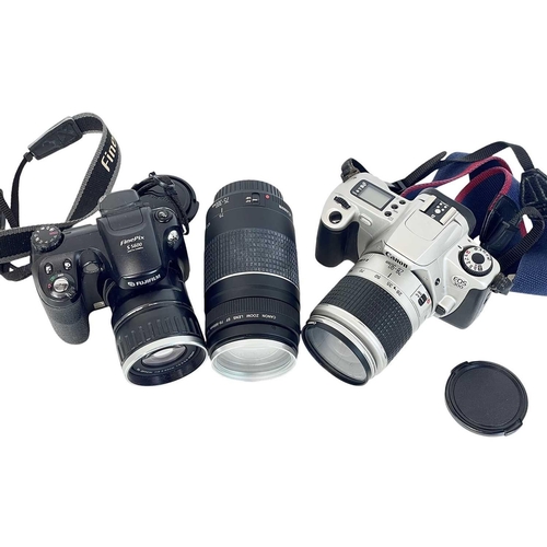 147 - A Canon EOS 300 camera. With a 28-90mm Zoom lens1:4-5.6, together with a 75-300 mm zoom lens, two ca... 