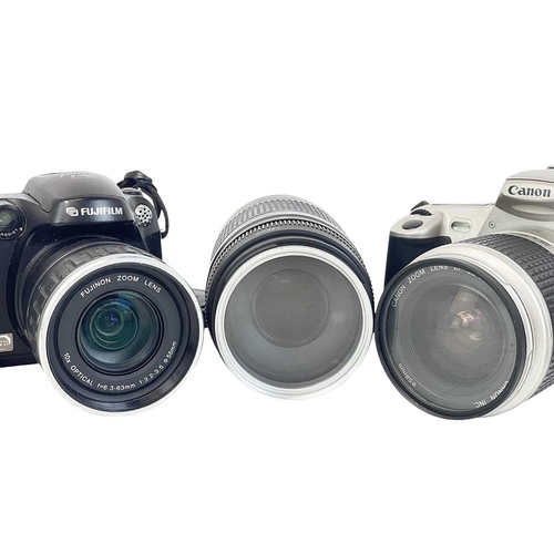 147 - A Canon EOS 300 camera. With a 28-90mm Zoom lens1:4-5.6, together with a 75-300 mm zoom lens, two ca... 