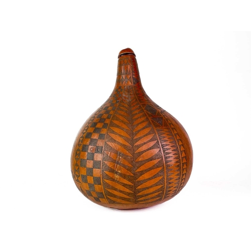 15 - A large carved gourd. Decorated with an African buffalo and an eagle bordered with geometric designs... 