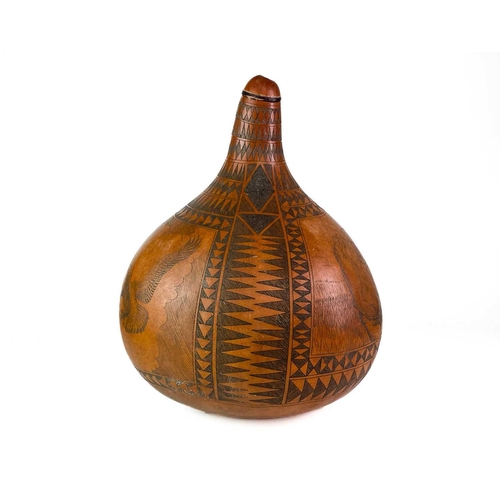 15 - A large carved gourd. Decorated with an African buffalo and an eagle bordered with geometric designs... 