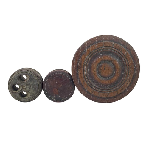 152 - A collection of treen. To include a stacking treen cylinder with an inset metal disc to each section... 