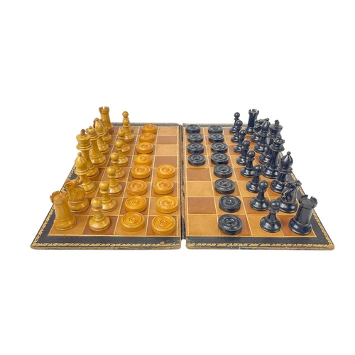 161 - A boxwood and ebonised chess set. Height of the kings 9cm, together with a set of draughts or checke... 