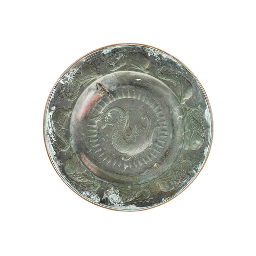 167 - A J. & F. Pool, Hayle copper charger. Repousse decorated with a stylised dolphin to the centre and f... 