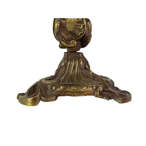 18 - A pair of French rococo style brass candlesticks. 19th century, with typical leaf and scroll casting... 