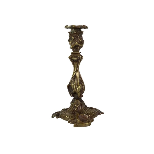 18 - A pair of French rococo style brass candlesticks. 19th century, with typical leaf and scroll casting... 