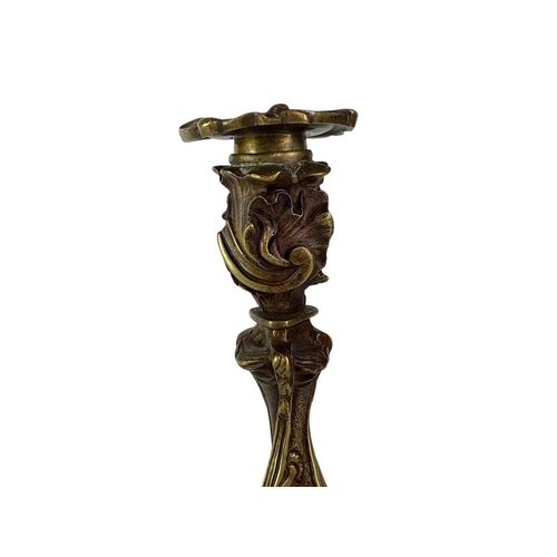 18 - A pair of French rococo style brass candlesticks. 19th century, with typical leaf and scroll casting... 