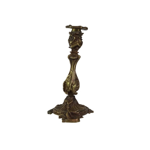 18 - A pair of French rococo style brass candlesticks. 19th century, with typical leaf and scroll casting... 