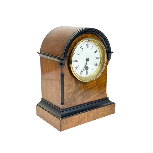 180 - A walnut cased continental mantel timepiece.. Circa 1890, with an arched top and ebonised detail, wh... 