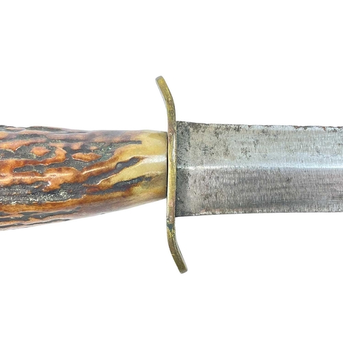 186 - A WWII Fairburn Sykes FS type fighting knife. With an antler handle, in a leather scabbard, length 2... 