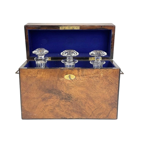 2 - A Victorian figured walnut campaign style tantalus. With folding brass side handles and fitted with ... 