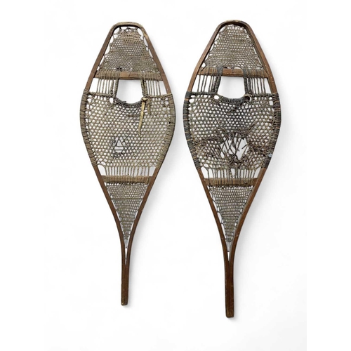 22 - A pair of Inuit bentwood snow shoes. Early 20th century, with the original gut stringing, length 108... 