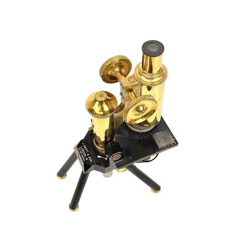 236 - A brass and black lacquered compound microscope by J Swift & Son, London. With rack and pinion cours... 