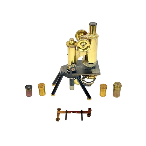 236 - A brass and black lacquered compound microscope by J Swift & Son, London. With rack and pinion cours... 