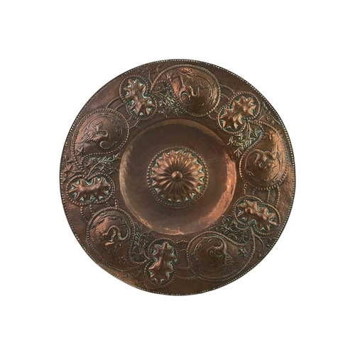 24 - An Arts and Crafts circular copper dish. John Pearson style, the copper of good gauge and repousse d... 