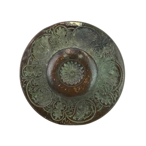 24 - An Arts and Crafts circular copper dish. John Pearson style, the copper of good gauge and repousse d... 