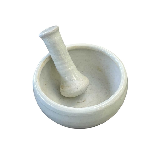 290 - A Leach Pottery porcelain celadon glazed pestle and mortar. Impressed marks, diameter 12cm.