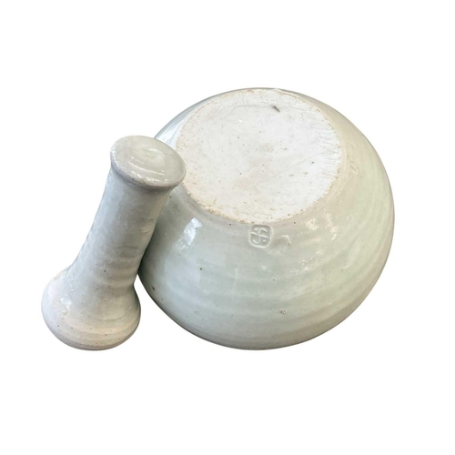 290 - A Leach Pottery porcelain celadon glazed pestle and mortar. Impressed marks, diameter 12cm.