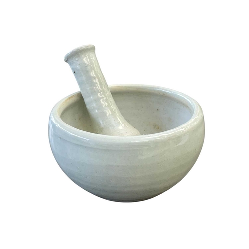 290 - A Leach Pottery porcelain celadon glazed pestle and mortar. Impressed marks, diameter 12cm.