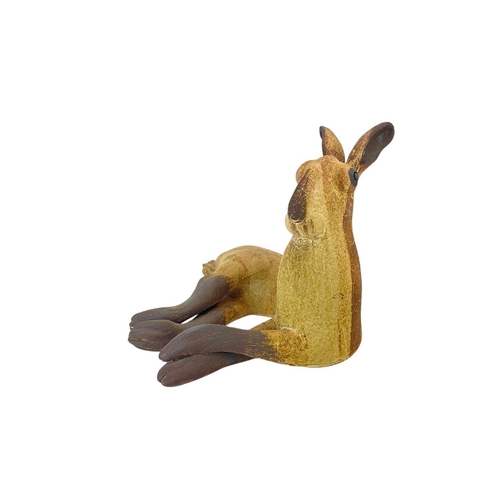 298 - A Michelle Cowmeadow studio pottery hare. With textured unglazed finish and brown markings, length 3... 