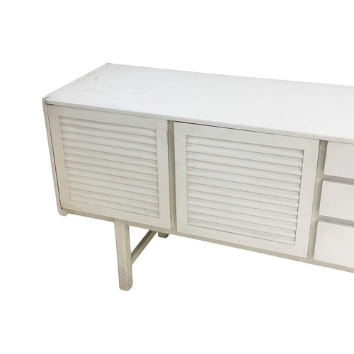 303 - An A H Mcintosh mid-century white finish sideboard. With three louvre effect doors, and three drawer... 