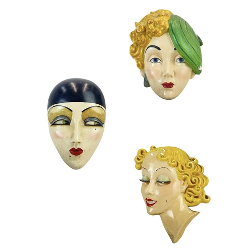 32 - An Art Deco plaster face mask wall plaques of pierot. Height 19cm together with two other Art Deco f... 